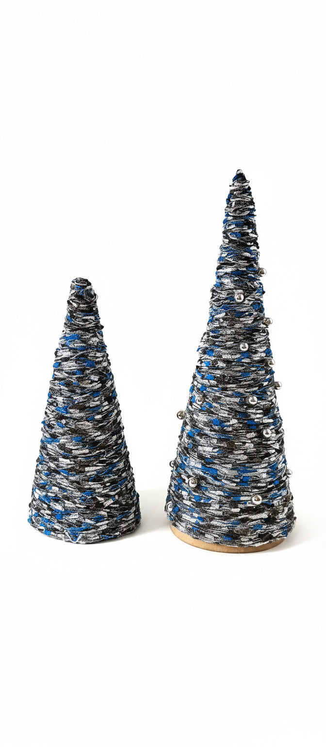 Two decorative Christmas trees made of yarn on a gray surface with a neutral background.